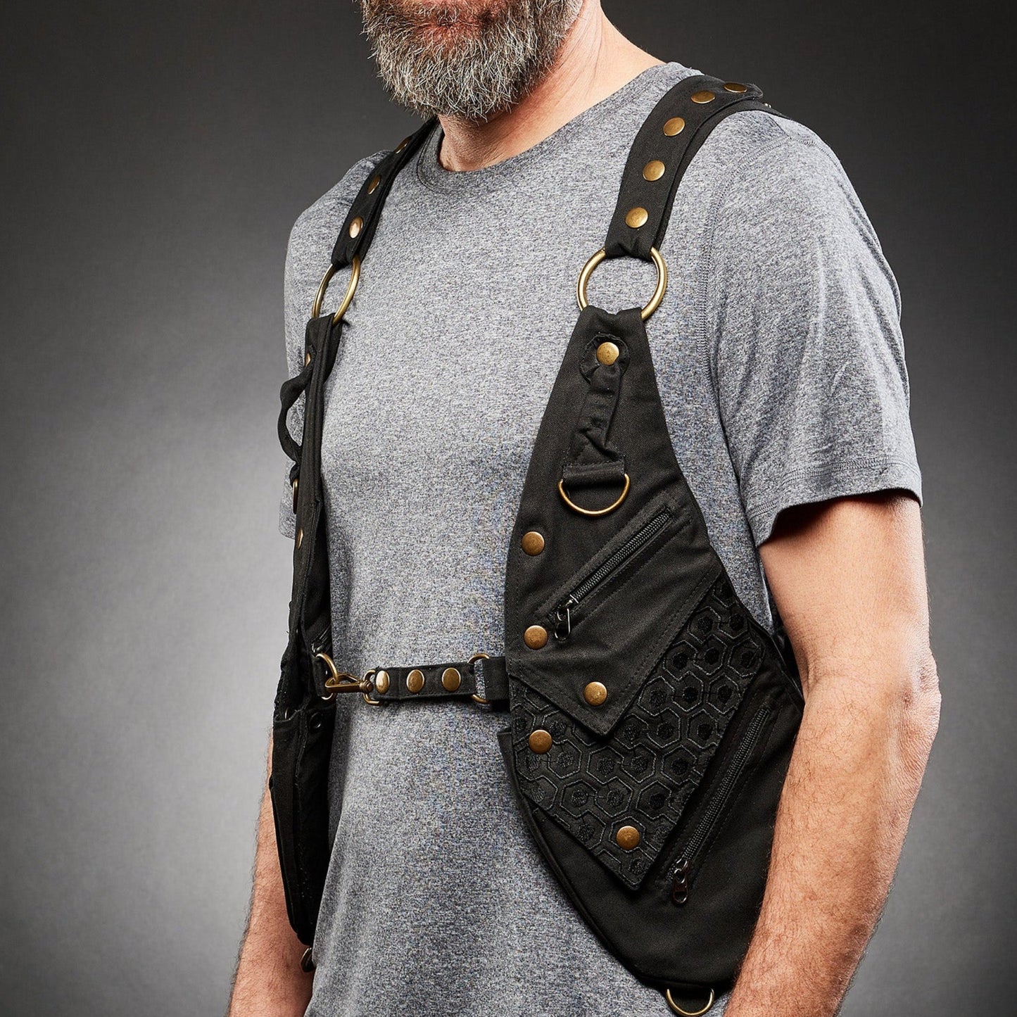 Bryan Smart, Lead Designer of Rigged Thing, wearing the Signature Holster Rig Spec Alpha-04  in black cotton twill with industrial bronze hardware